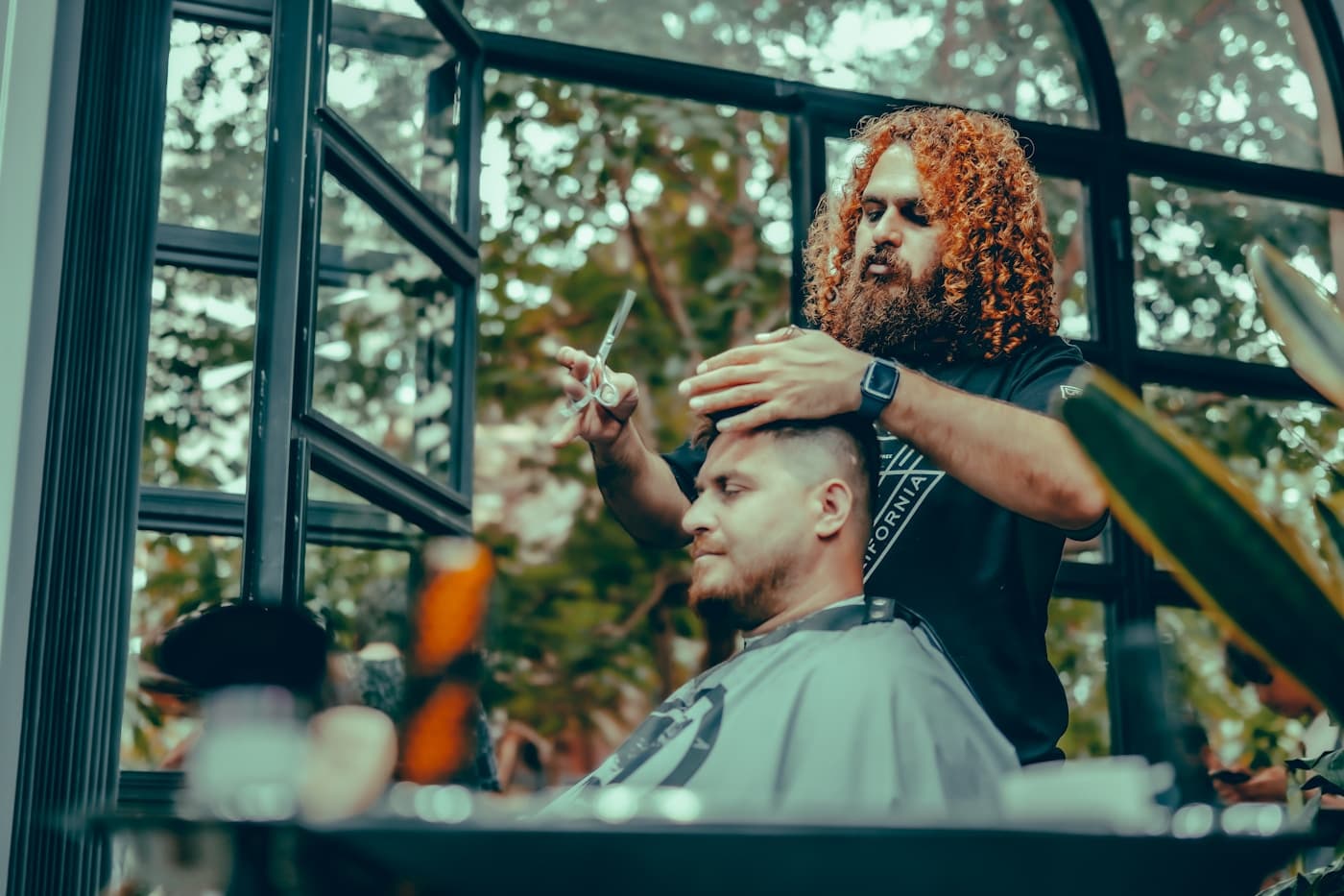 Skin fade in progress by the atelier window